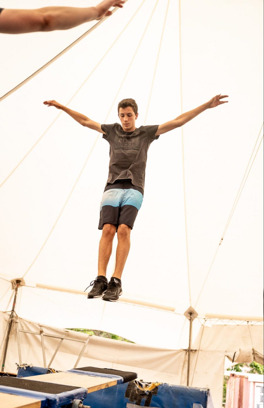 a teenager jumps on a teeterboard