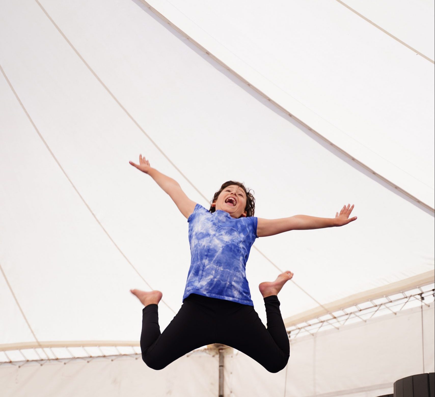 A child jumps exuberantly in the air